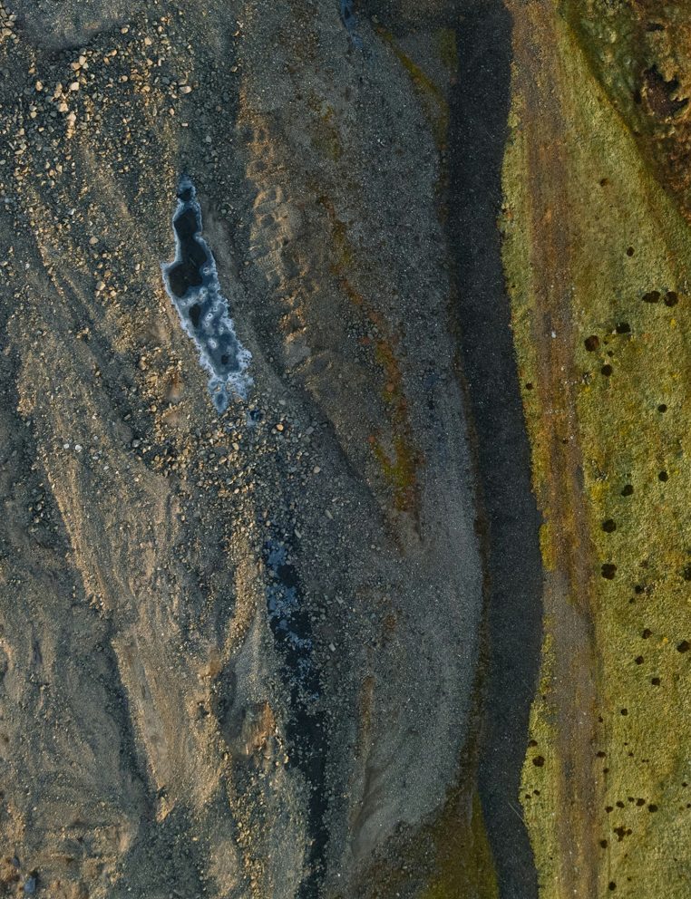 Satellite observation of an open-pit mine and processing conveyors